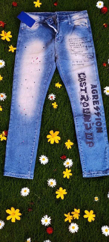 Blue jeans with text on a grassy